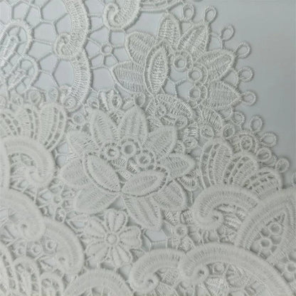 A close-up of the European Classical Crochet Embroidery Exquisite Table Mat from Costa Rica Coffee Friends, showcasing intricate white lace fabric with detailed flower and leaf designs. The light, solid background accentuates the delicate textures and craftsmanship, making it perfect for a bar counter or as a coaster for wine glasses and coffee cups at birthday parties.